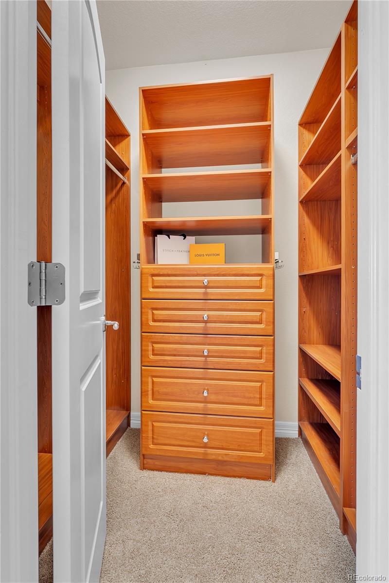 8053 East Maple Avenue Denver, CO 80230 - Photo 28 of 49 a view of walk in closet with clothes