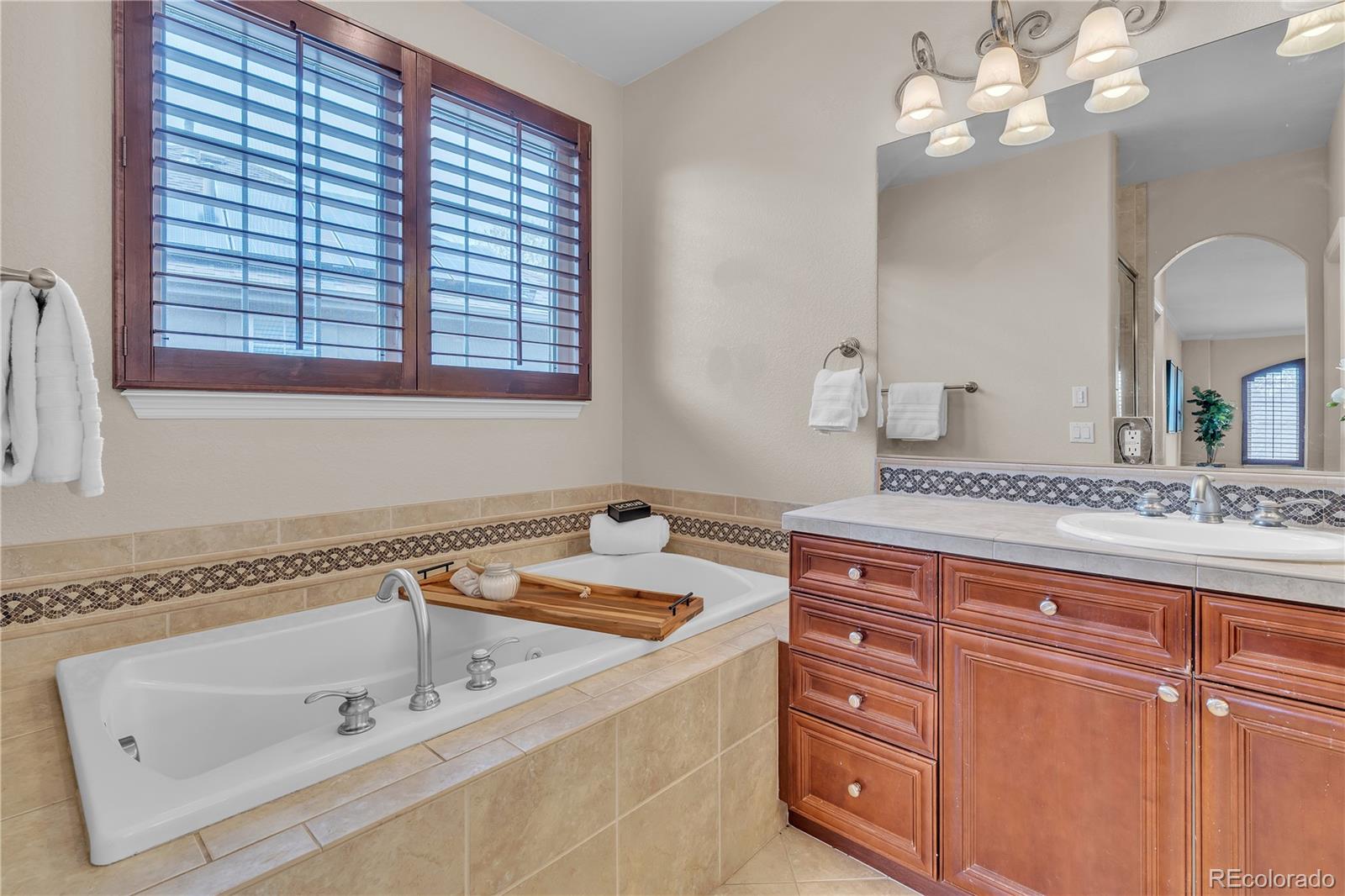 8053 East Maple Avenue Denver, CO 80230 - Photo 29 of 49 a bathroom with a sink and a mirror