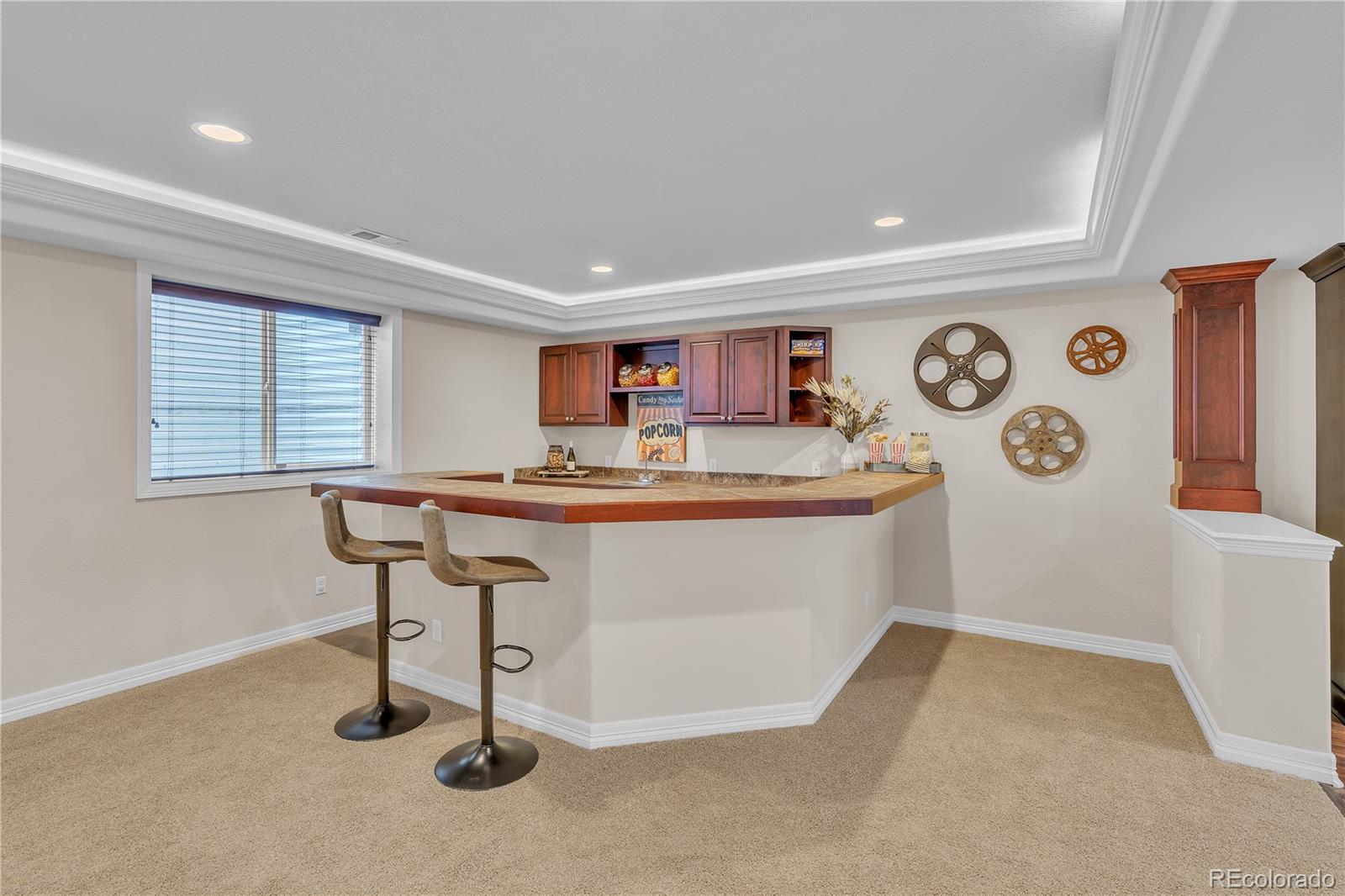 8053 East Maple Avenue Denver, CO 80230 - Photo 37 of 49 a room with kitchen island stainless steel appliances a couch and a window