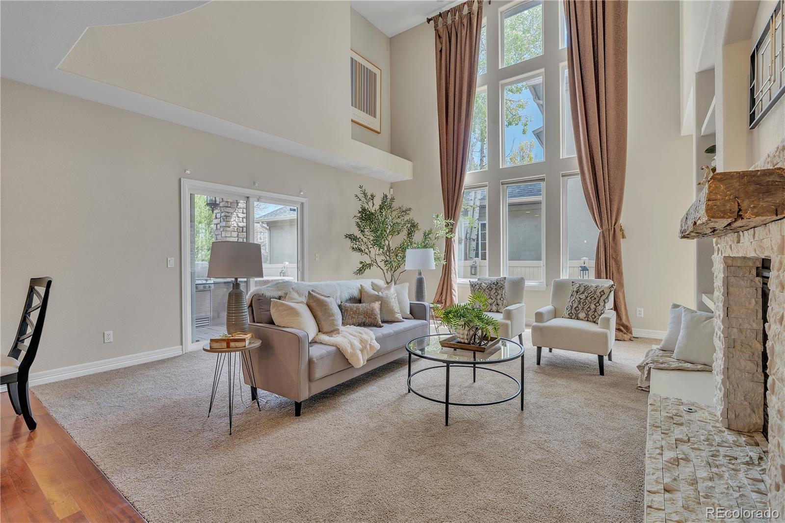 8053 East Maple Avenue Denver, CO 80230 - Photo 4 of 49 a living room with furniture and a large window