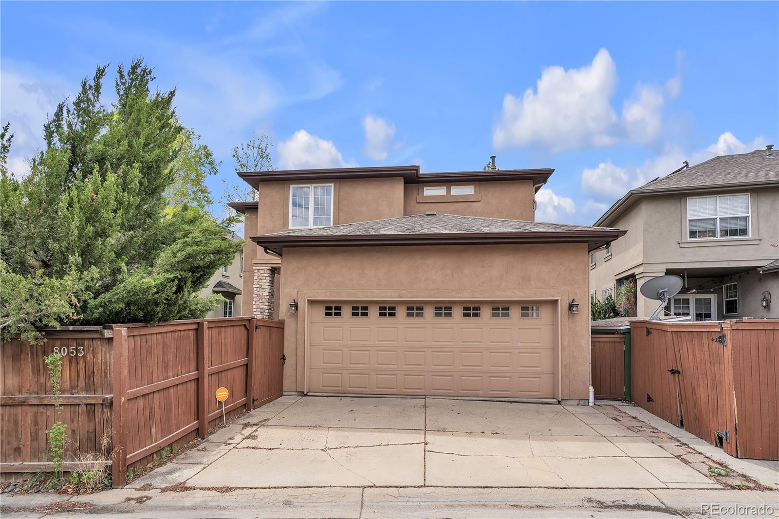 8053 East Maple Avenue Denver, CO 80230 - Photo 45 of 49 a front view of a house with a garage
