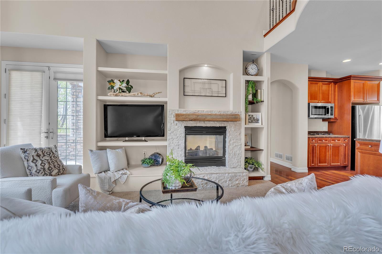 8053 East Maple Avenue Denver, CO 80230 - Photo 5 of 49 a living room with furniture and a flat screen tv