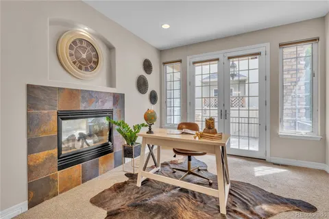 a kitchen with stainless steel appliances granite countertop a refrigerator a sink dishwasher a stove with wooden cabinets and floor