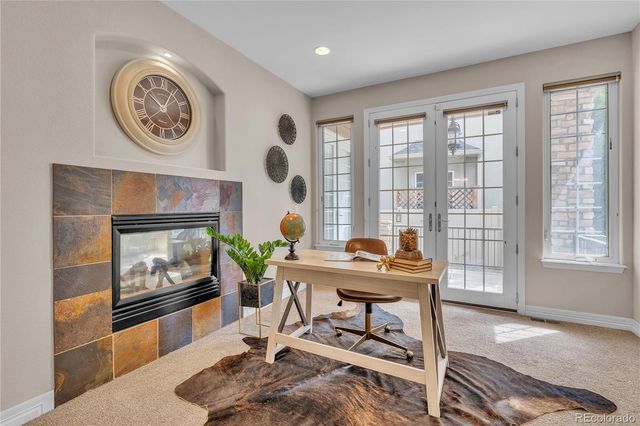 a kitchen with stainless steel appliances granite countertop a refrigerator a sink dishwasher a stove with wooden cabinets and floor