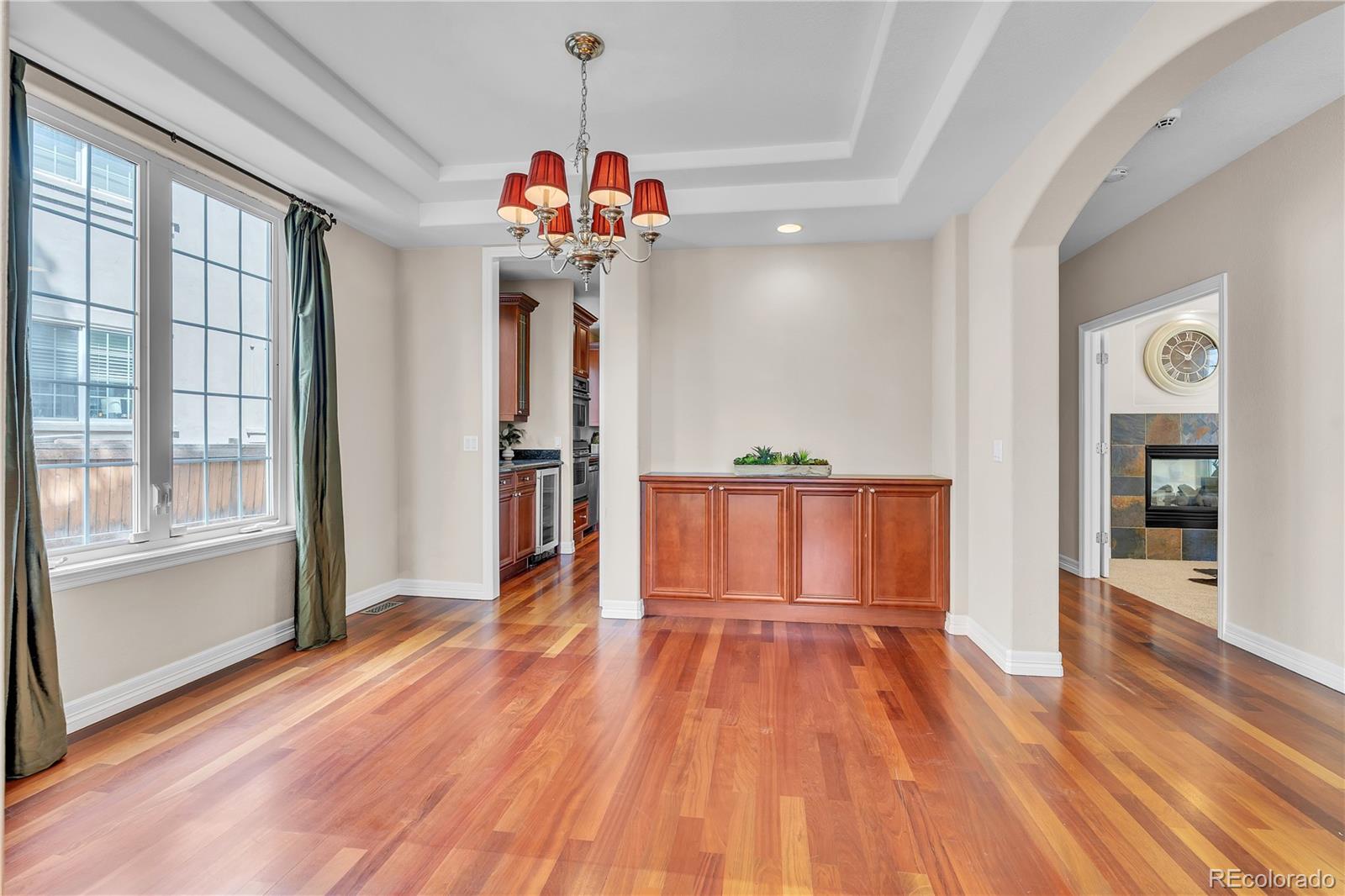 8053 East Maple Avenue Denver, CO 80230 - Photo 10 of 49 a view of a hallway with wooden floor and a kitchen