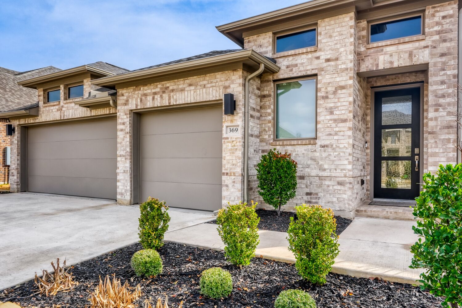 369 Prickly Poppy Loop Kyle, TX 78640 - Photo 1 of 1 View of front facade featuring a garage, driveway, brick siding, and a shingled roof