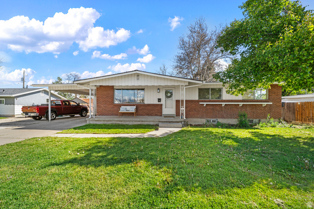 2267 West 4350th Street South Roy, UT 84067 - Photo 2 of 32 View of front of property with an attached carport, brick siding, driveway, and covered porch