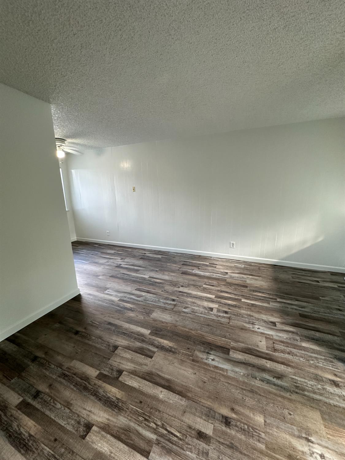 1069 Cherry Lane, Unit D Clovis, CA 93612 - Photo 3 of 18 a view of room and wooden floor