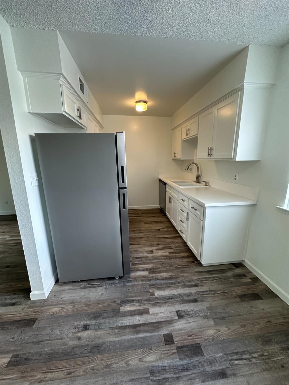 1069 Cherry Lane, Unit D Clovis, CA 93612 - Photo 5 of 18 a large room with lot of cabinets and wooden floor
