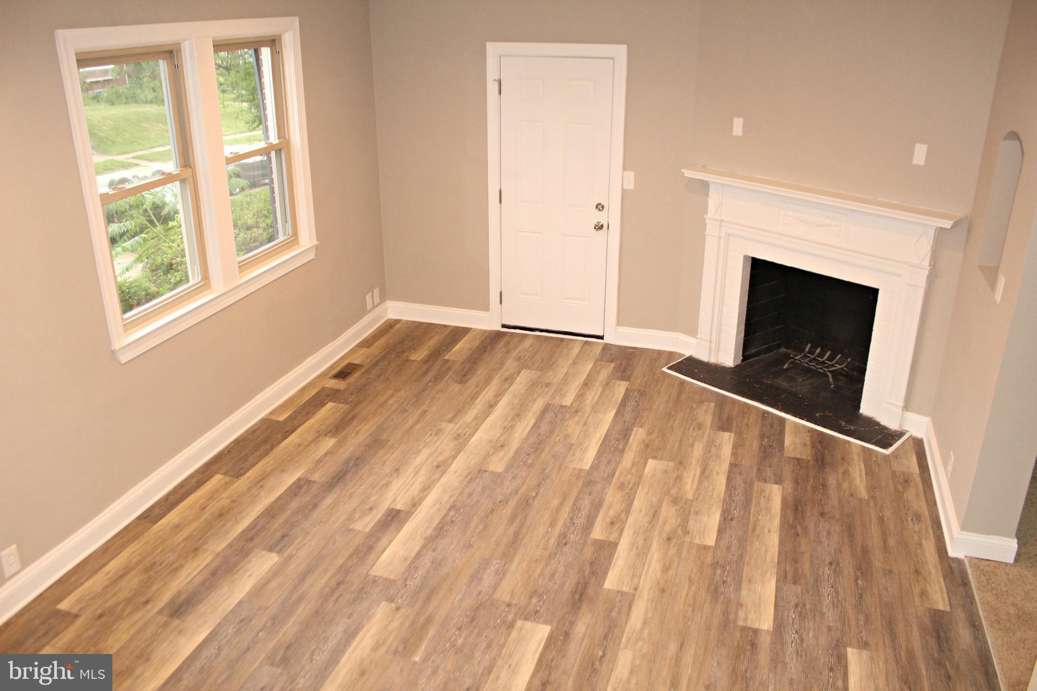 3608 Dennlyn Road Baltimore, MD 21215 - Photo 9 of 26 Large living room with luxury vinyl plank flooring