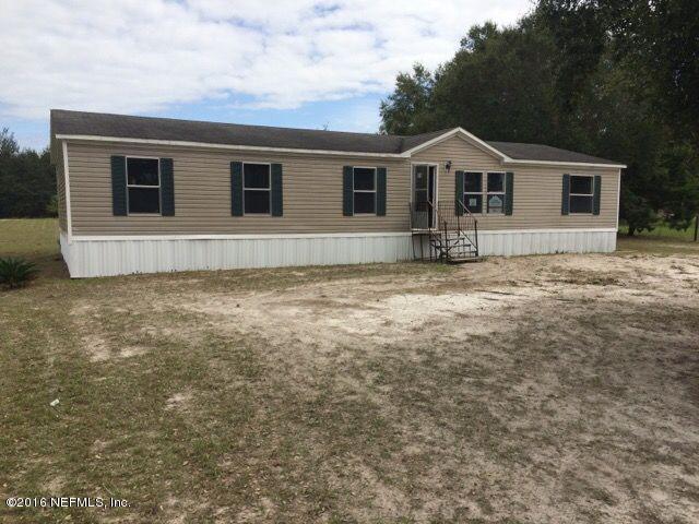 174 Gorbutt Road Crescent City, FL 32112 - Photo 1 of 13 a view of a yard in front of a house with a yard