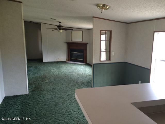 174 Gorbutt Road Crescent City, FL 32112 - Photo 9 of 13 a view of livingroom with furniture and window