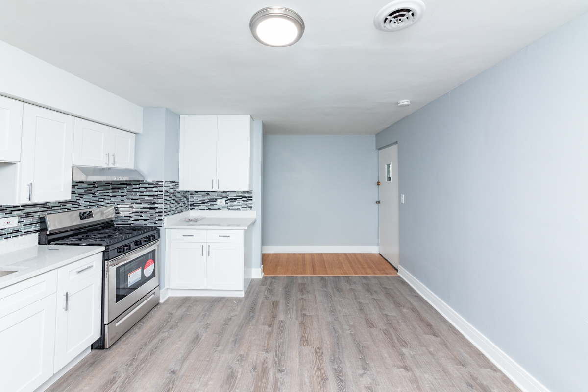 9450 Washington Road, Unit 4B Morton Grove, IL 60053 - Photo 3 of 16 a kitchen with a stove a sink and a refrigerator