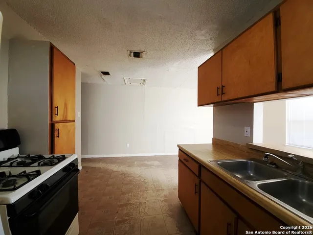 a kitchen that has a sink and a stove