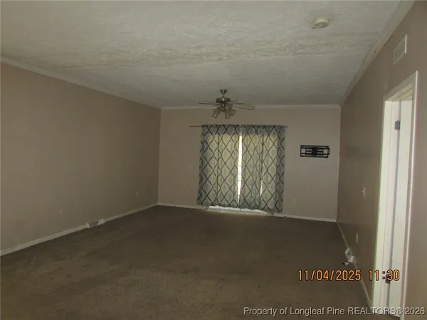 an empty room with windows and entrance