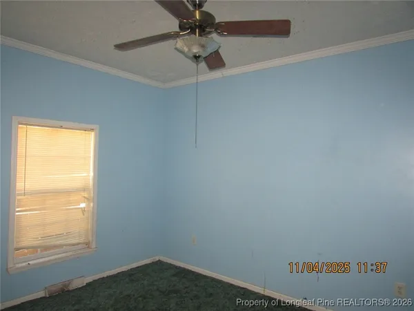 a view of an empty room and a window