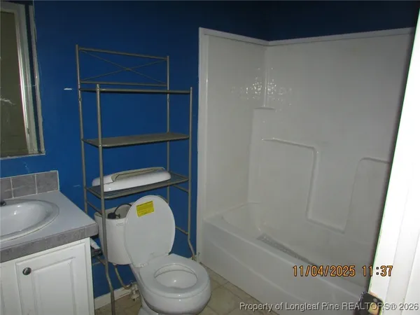 a bathroom with a toilet a sink and bathtub