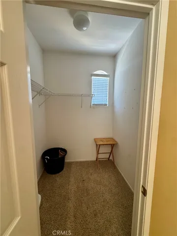 a view of a livingroom with furniture and a window