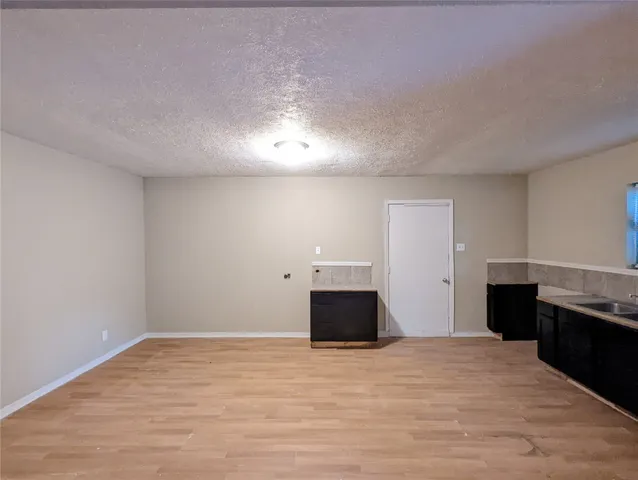 a view of a kitchen with a sink and a stove