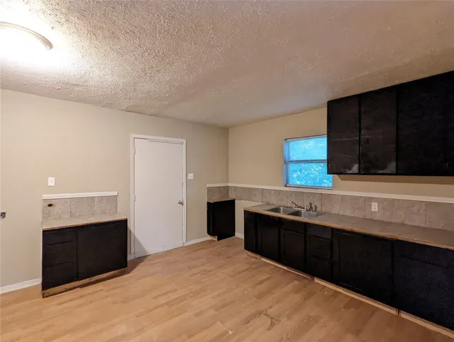 a kitchen with stainless steel appliances a sink and a stove