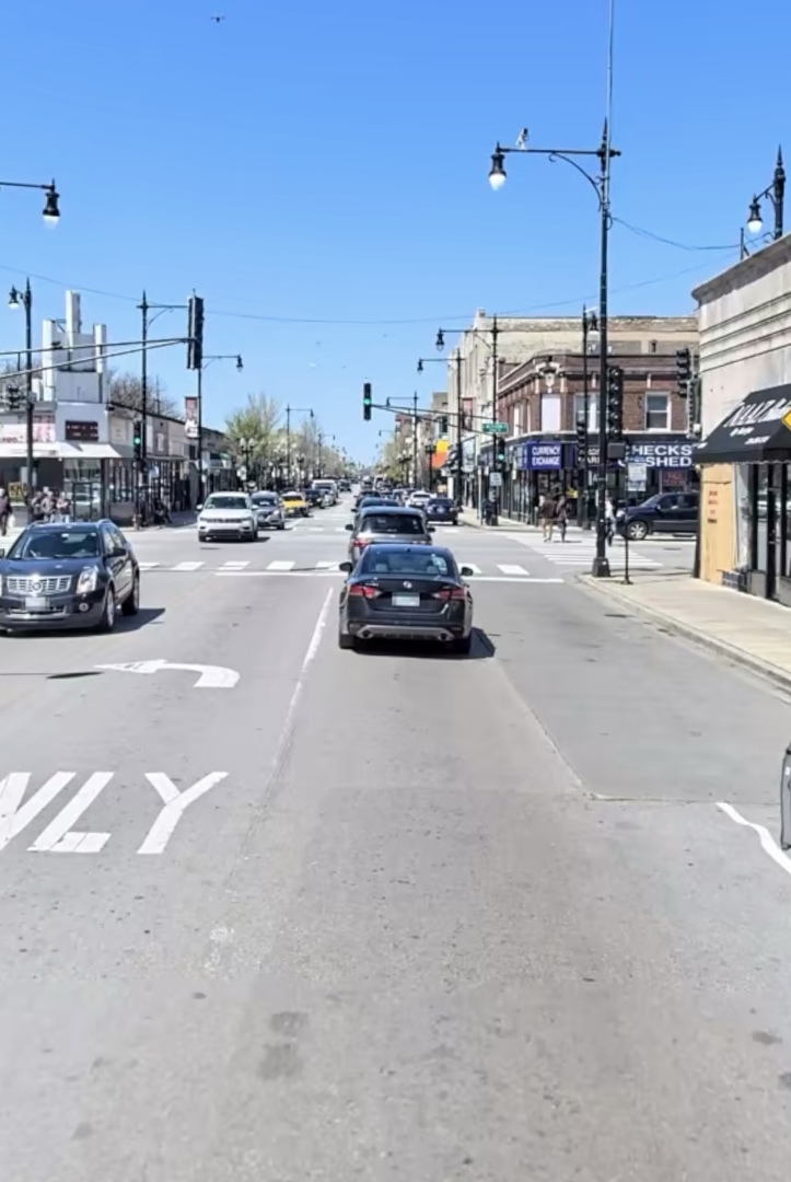 2349 West Devon Avenue, Unit 3F Chicago, IL 60659 - Photo 2 of 6 a view of a city street with cars