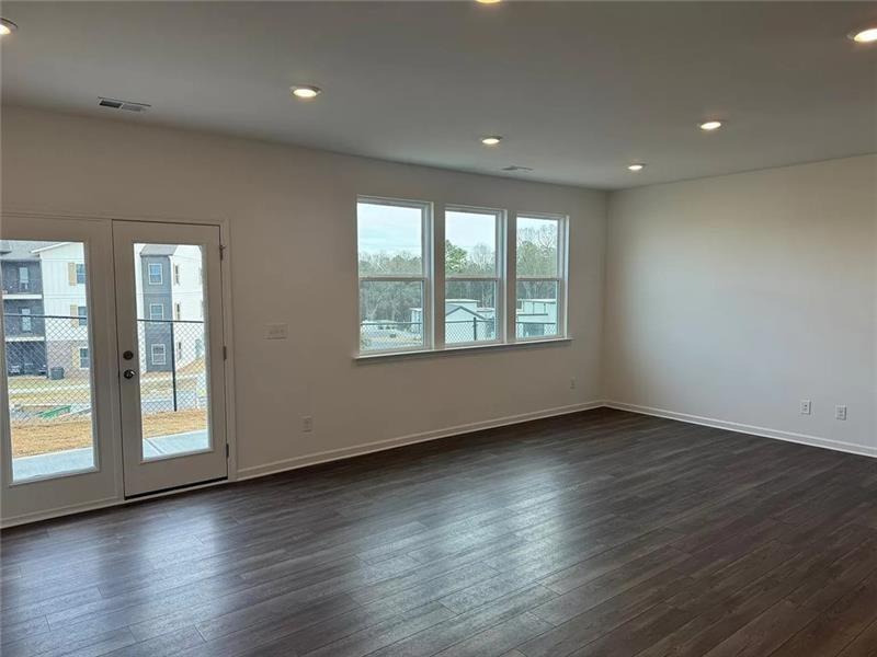 100 Mission Boulevard Pendergrass, GA 30567 - Photo 3 of 17 an empty room with wooden floor and windows