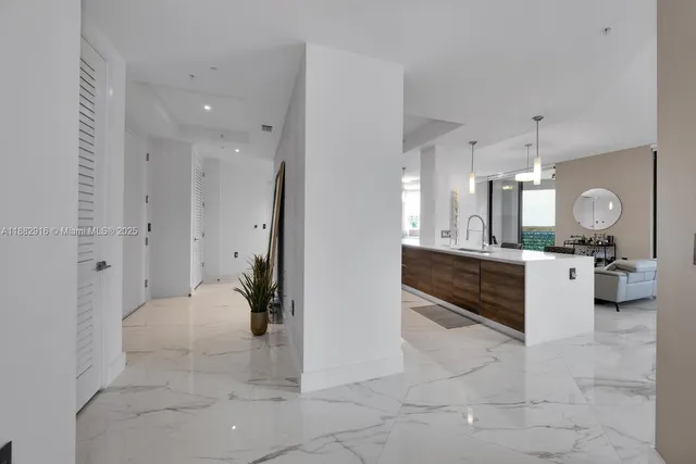 a bathroom with a sink a mirror a vanity and shower