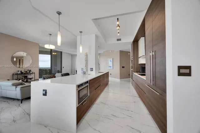 a large white kitchen with stainless steel appliances