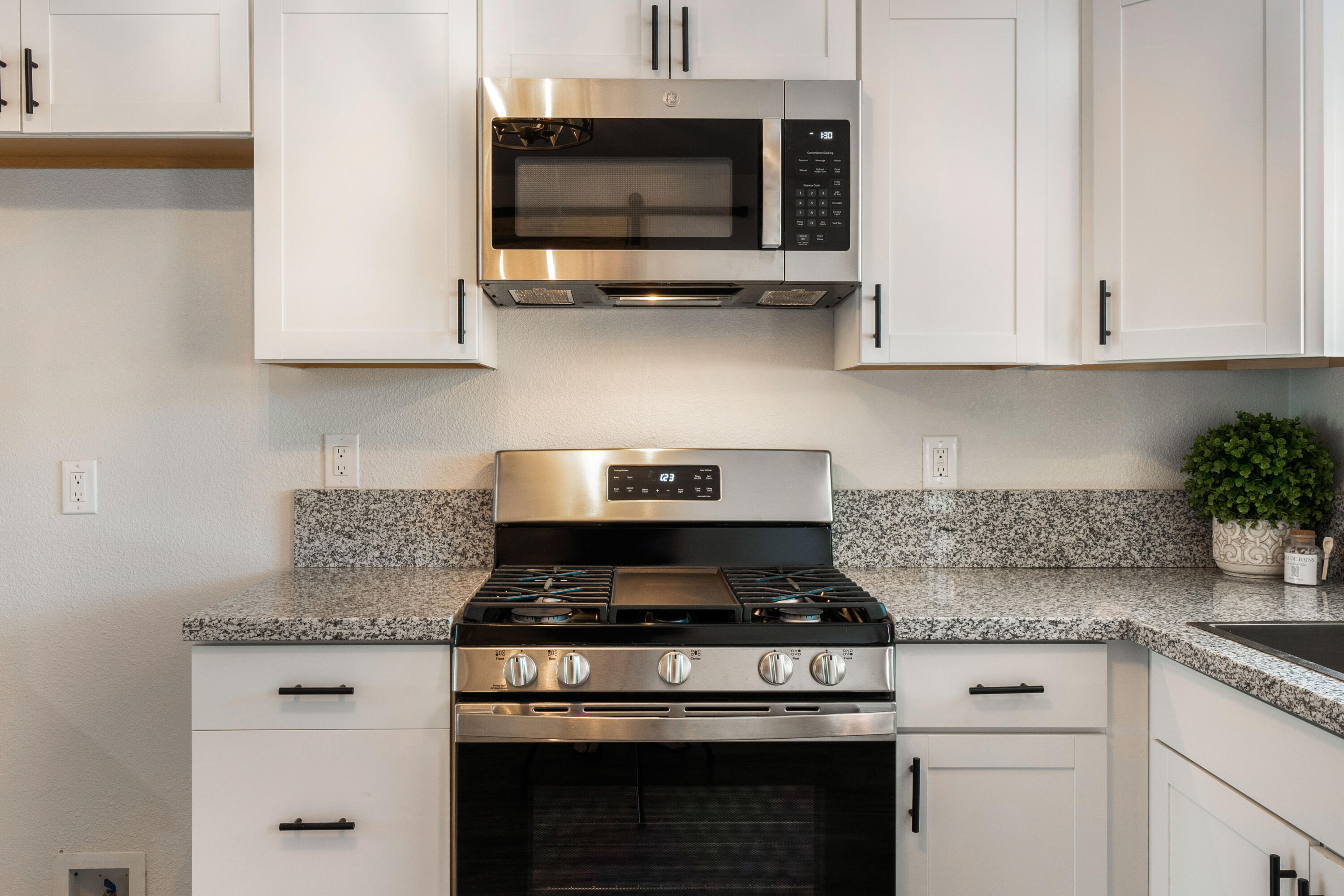 2712 Irwin Road Redding, CA 96002 - Photo 11 of 34 a kitchen with stainless steel appliances granite countertop white cabinets and a stove