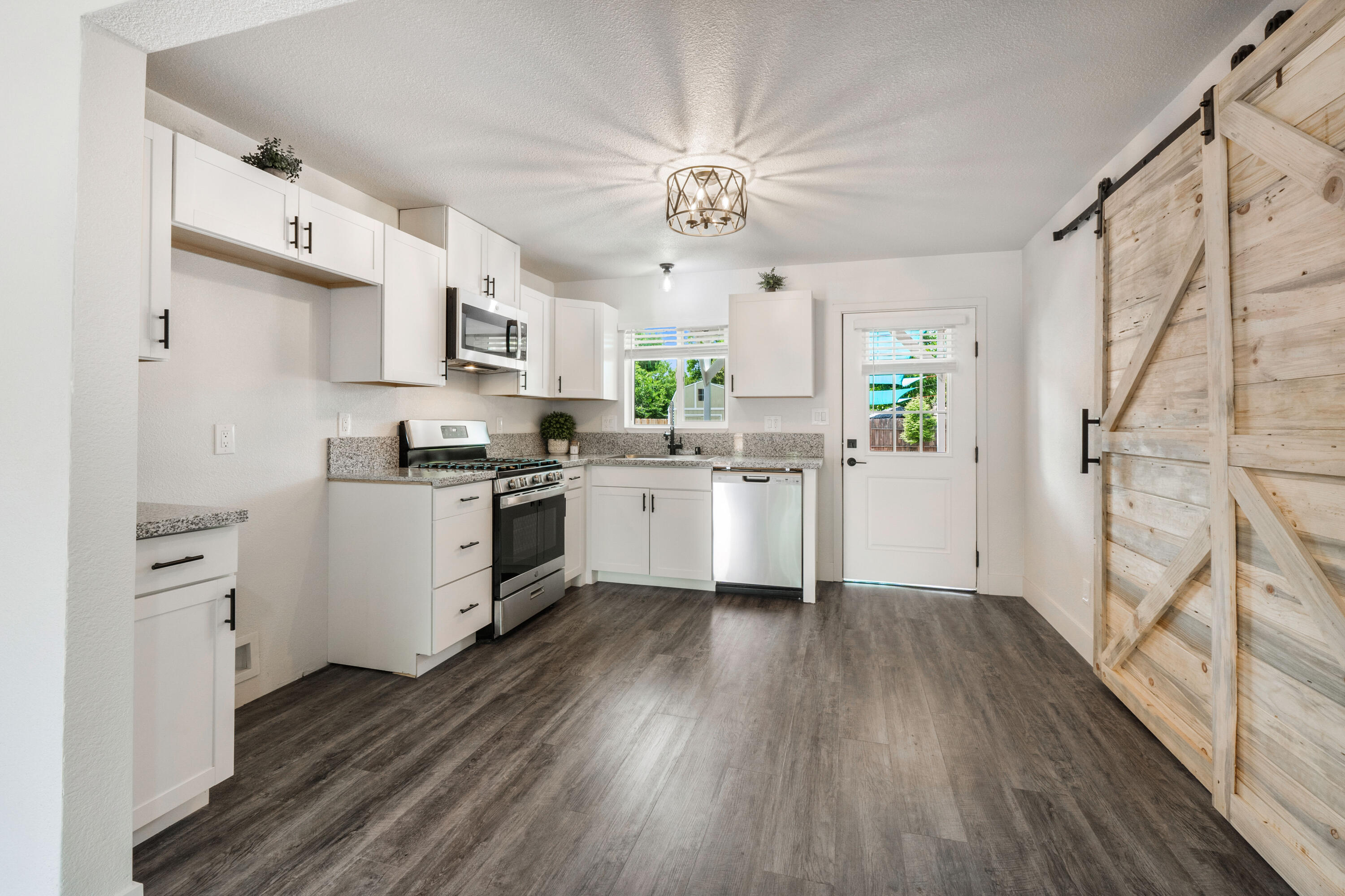 2712 Irwin Road Redding, CA 96002 - Photo 8 of 34 a kitchen with white cabinets and white appliances