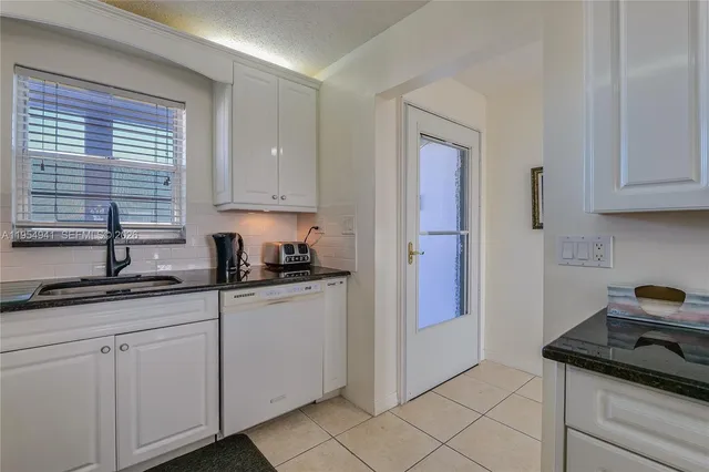 a kitchen with stainless steel appliances granite countertop a sink and a cabinets