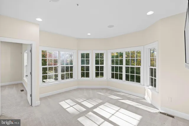 a living room with stainless steel appliances kitchen island granite countertop furniture and a rug