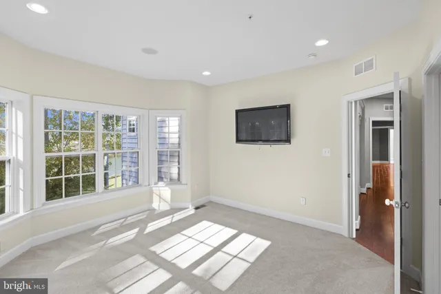 a view of a hallway with seating area