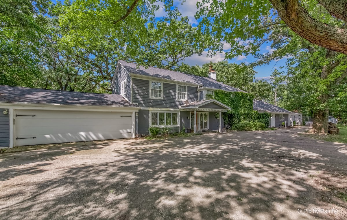 144 Algonquin Road Barrington Hills, IL 60010 - Photo 3 of 53 a front view of a house with a garden