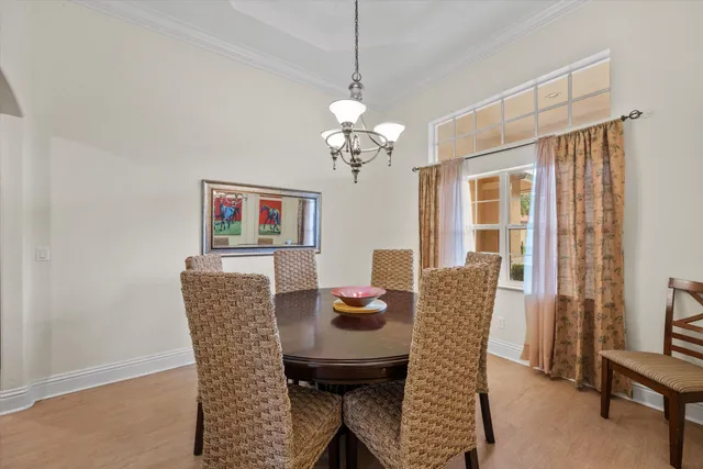 a dining room with furniture a chandelier and window