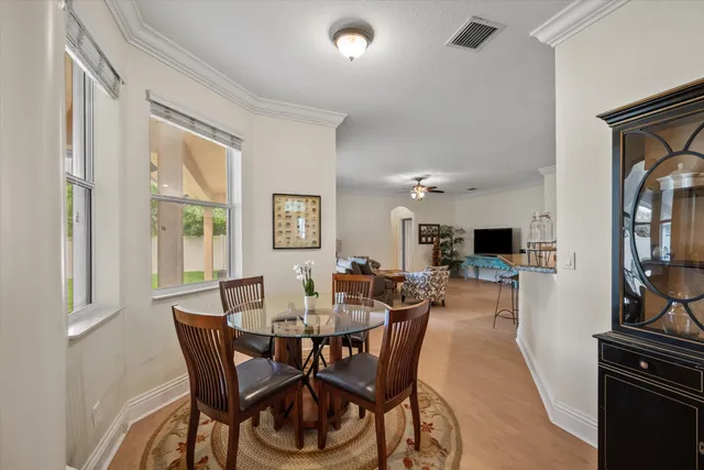 a view of a dining room with furniture and a window