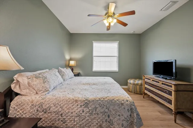 a bedroom with a bed and a chandelier