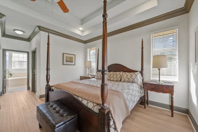a bedroom with a bed and a dresser next to a window