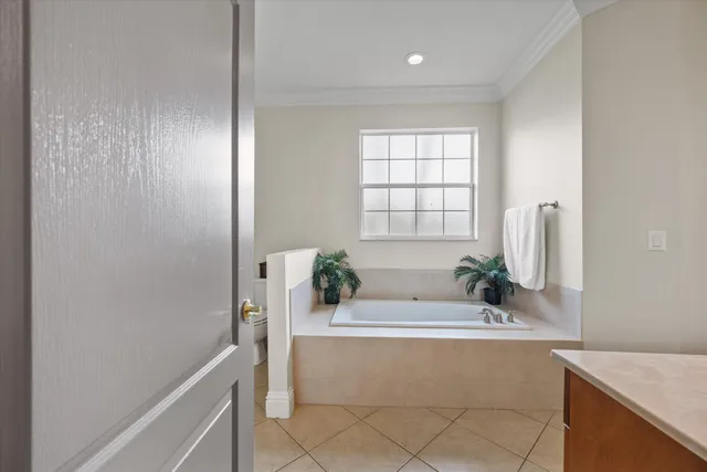 a bath tub sitting in a bathroom next to a window