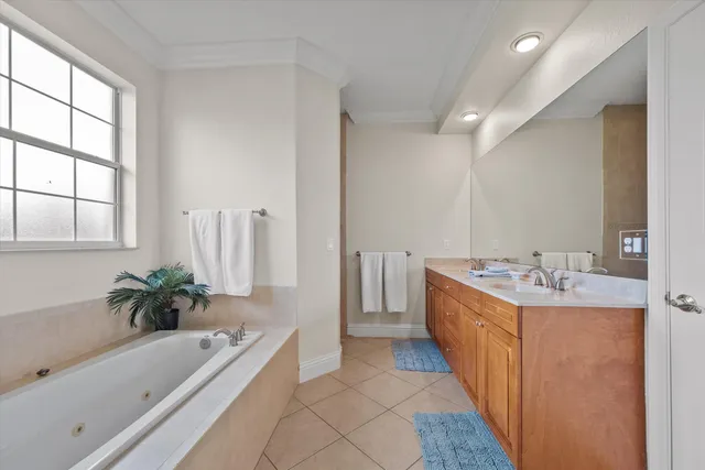 a bathroom with a tub sink and mirror