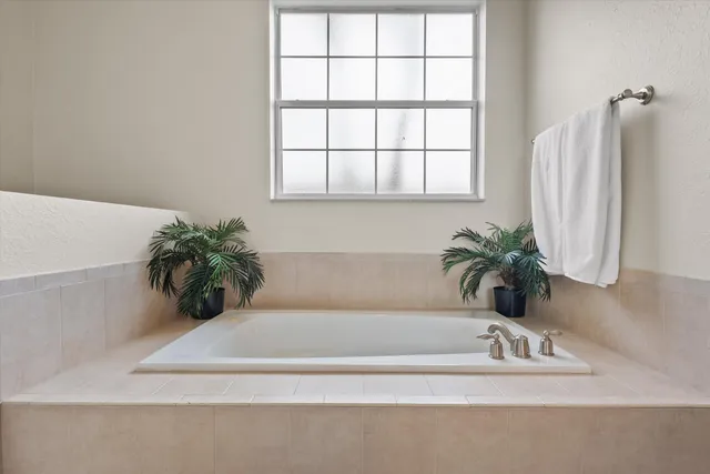 a bathroom with a bathtub and a window