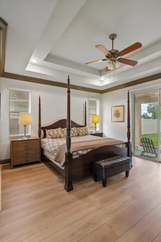 a spacious bedroom with a bed and ceiling fan