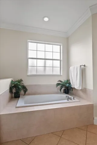 a bath tub sitting in a bathroom next to a window