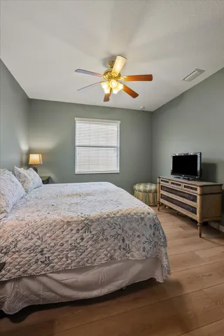 a bedroom with a bed and a lamp with window