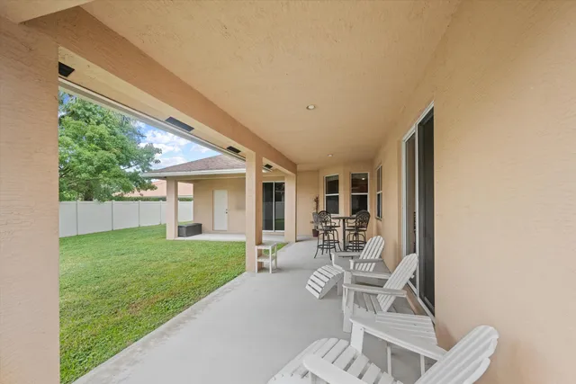 a house view with a sitting space and garden space