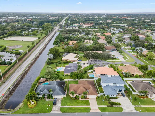 an aerial view of residential houses with outdoor space and swimming pool