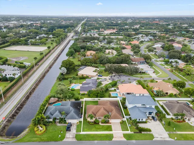an aerial view of residential houses with outdoor space and swimming pool