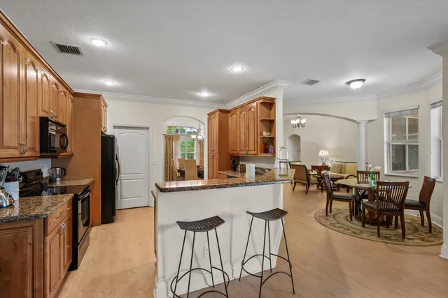 a large kitchen with lots of counter space and breakfast area