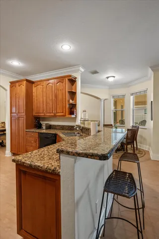 a kitchen with granite countertop lots of counter top space and living room