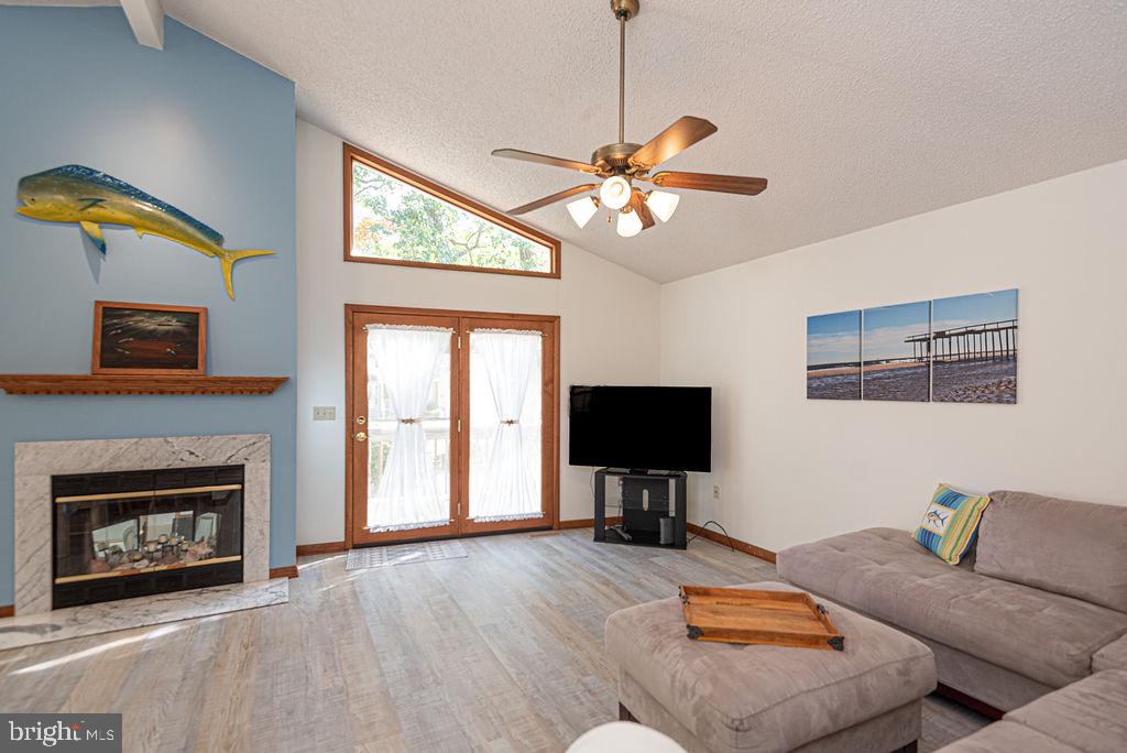 54 Abbyshire Road Ocean Pines, MD 21811 - Photo 10 of 43 a living room with furniture a fireplace and a flat screen tv